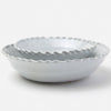 A pair of nested ceramic bowls with a scalloped, wavy rim, shown in a light gray color on a clean white background.
