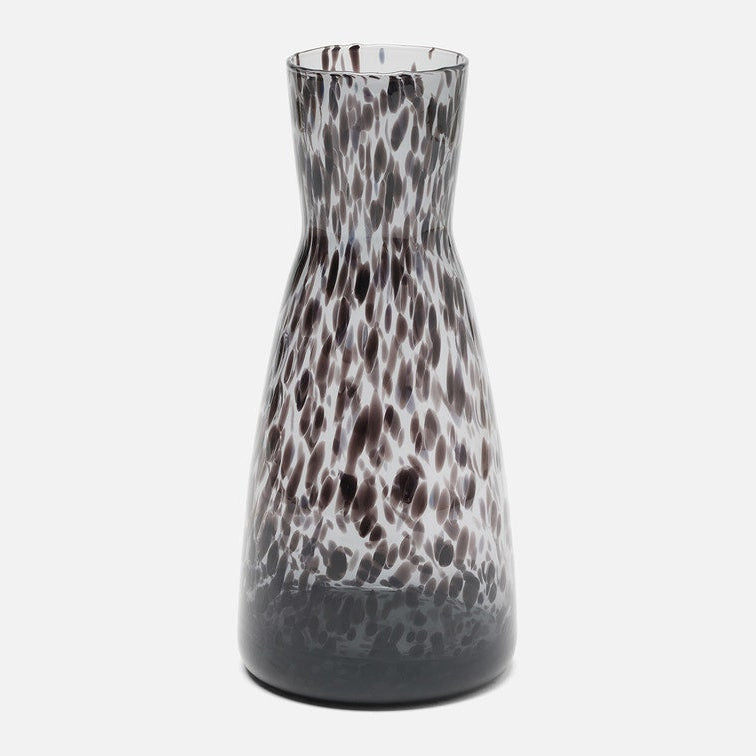 A tall, flared glass carafe with a dark brown and white leopard-like spotted pattern, shown against a plain light gray background.