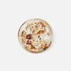 Amber and white swirled serving bowl on white background