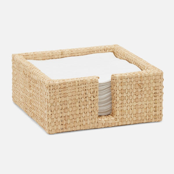 A square woven natural fiber napkin holder basket containing white paper napkins, shown on a clean light gray background.