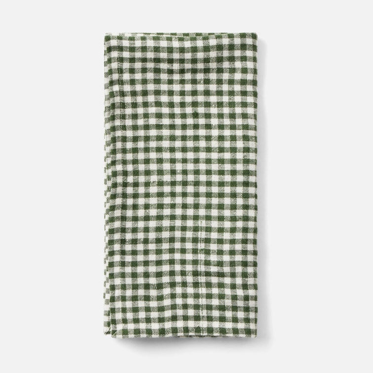 A folded green and white gingham checkered cloth napkin or tea towel, displayed vertically against a clean, light gray background.