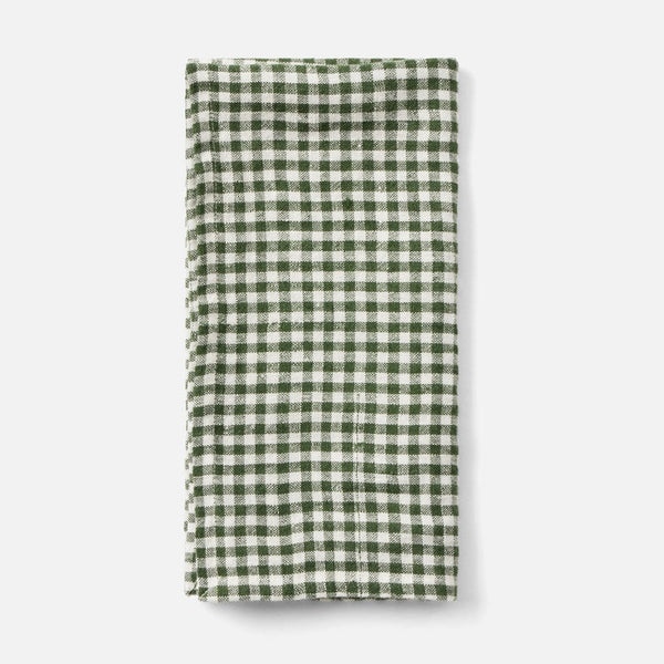 A folded green and white gingham checkered cloth napkin or tea towel, displayed vertically against a clean, light gray background.