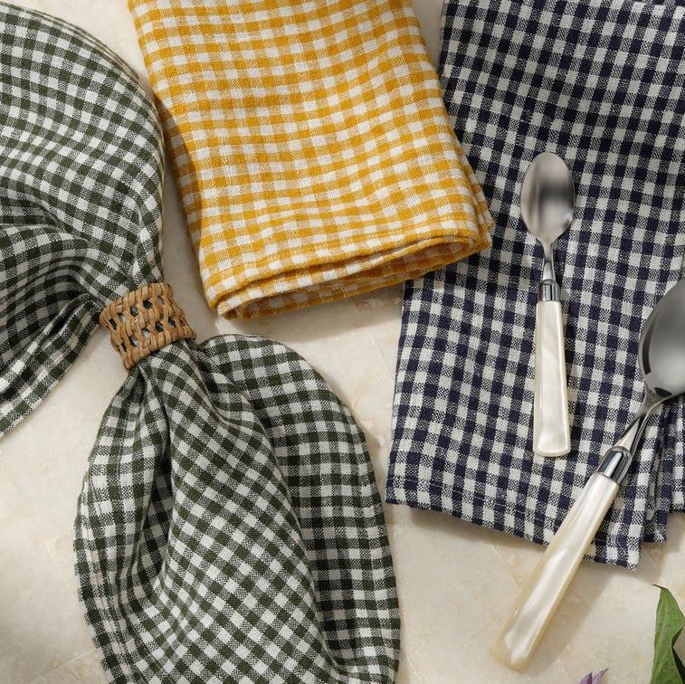 Checkered napkins and spoons on a marble surface