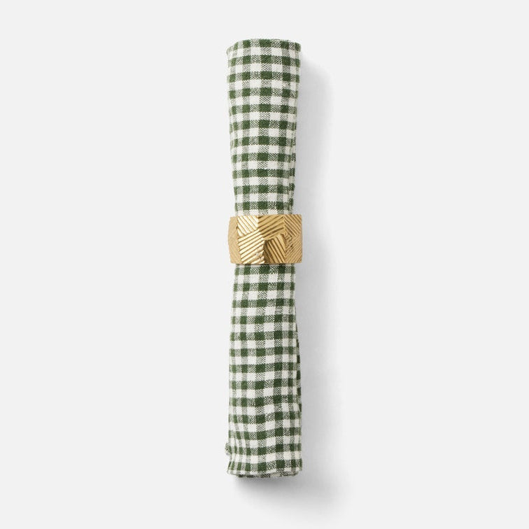 A rolled green and white gingham check napkin held in place by a textured gold paper ring, shown on a clean white background.