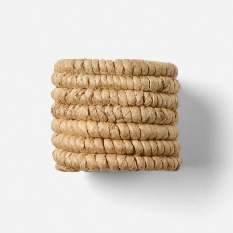Woven napkin rings on a white background