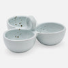 Three small stoneware bowls with a light blue-green glaze and dark speckles, arranged together on a plain white background.