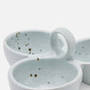 Stoneware snack dish with integrated loop handles, shown in a close-up studio shot on a white background. The dish has a pale icy blue-green glaze with scattered dark speckles inside.