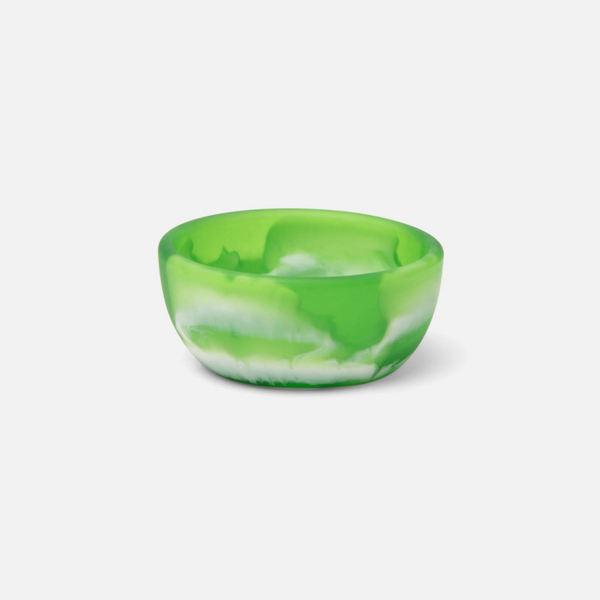 A two-tone resin serving bowl with a swirled pattern, predominantly green with white marbling.