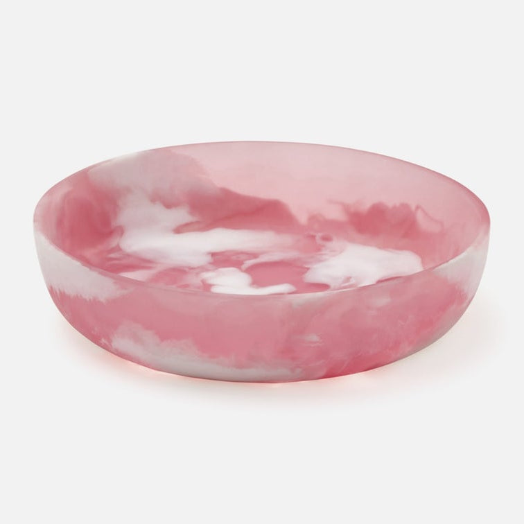 Pink and white marbled resin bowl on a light gray background