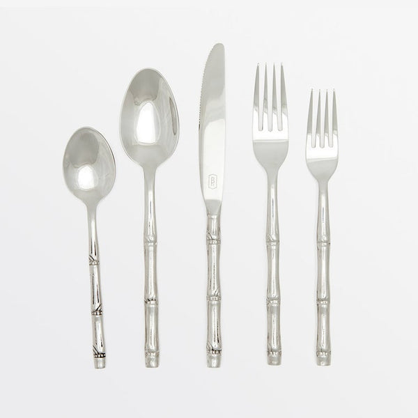 Set of silver cutlery including spoons, knife, and forks on a white background