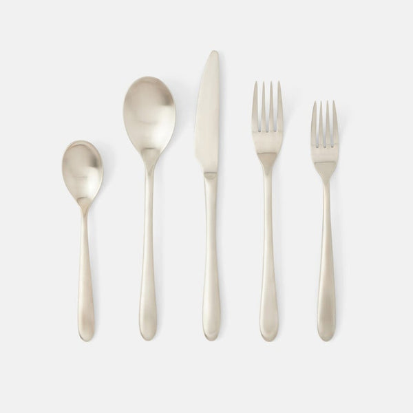 A five-piece flatware set in a brushed silver finish, arranged vertically in descending size order on a clean, light gray background. The set includes a dinner fork, a salad fork, a teaspoon, a tablespoon, and a dinner knife.
