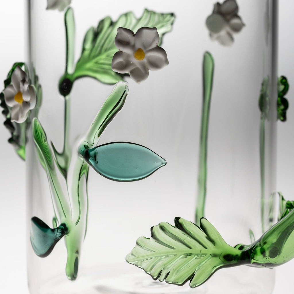 Clear glass with green floral designs on a white background
