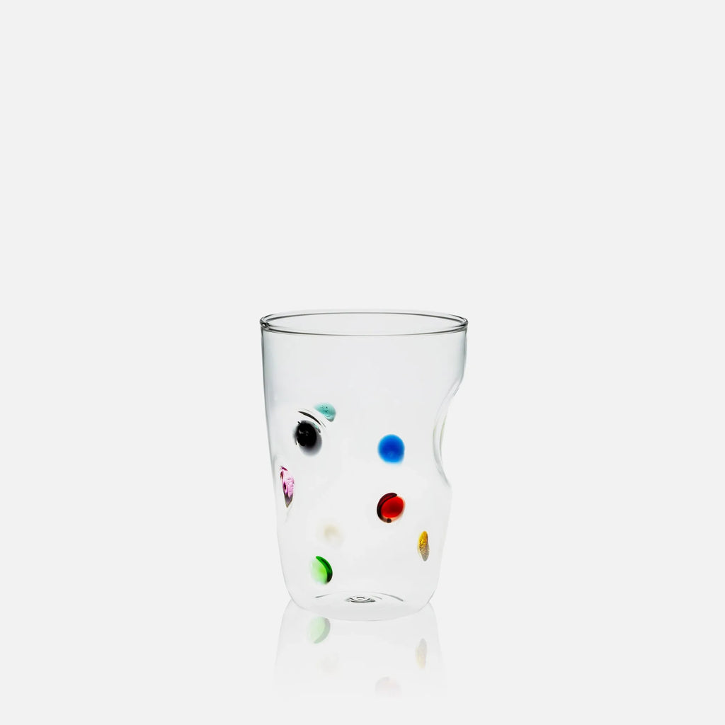 Clear glass with colorful dots on a white background