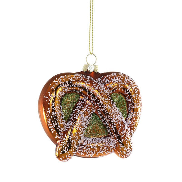 Glass pretzel ornament on white background