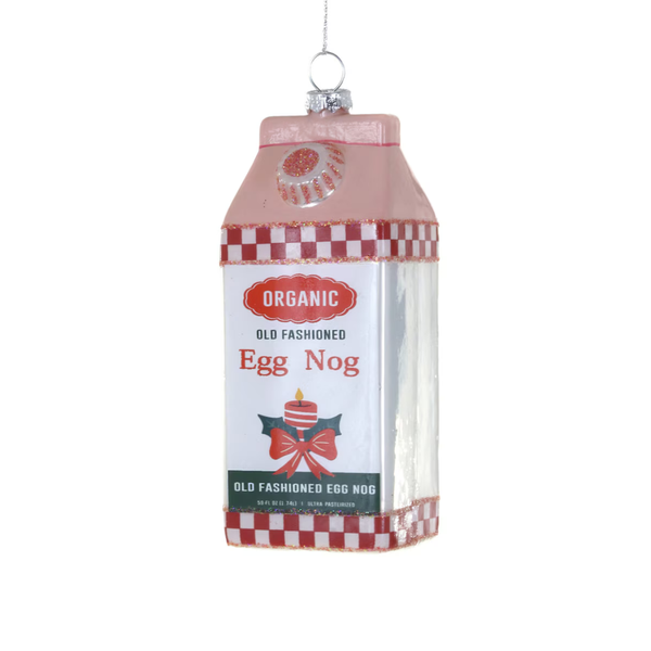 A milk carton-shaped hanging ornament featuring 'Organic Old Fashioned Egg Nog' text, a red-and-white check pattern, and a small bow graphic on a white background.