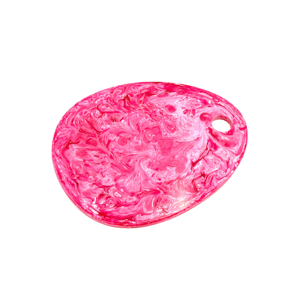 A pink and white marbled resin cheeseboard with a small hole on the right side, shown on a plain white background.