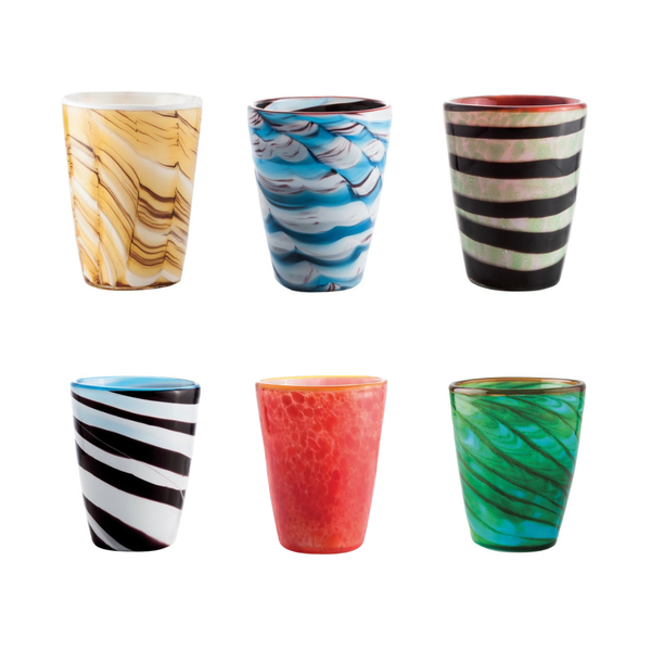Six colorful glass tumblers arranged in two rows of three on a plain white background. The tumblers feature various patterns including marbled swirls, stripes, and textured splatters in colors such as yellow, blue, black, red, and green.