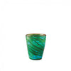 A small hand-blown glass tumbler with a marbled pattern of green, teal, and dark brown swirls, set against a plain white background.