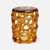 Hexagonal amber-colored stool with a unique lattice design on a white background