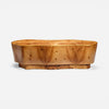 A carved wooden coffee table with a thick, rounded top and a natural burl wood grain pattern, shown against a plain light gray background.
