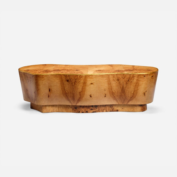 A carved wooden coffee table with a thick, rounded top and a natural burl wood grain pattern, shown against a plain light gray background.