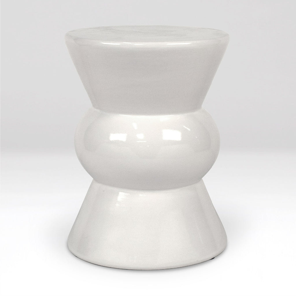 A glossy white ceramic stool with a tiered, hourglass-like design, photographed against a seamless light gray studio background.