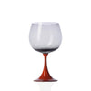 Wine glass with a red base on a white background