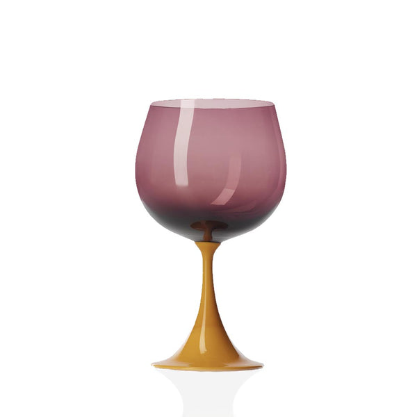 Purple and yellow glass wine glass on flat white background