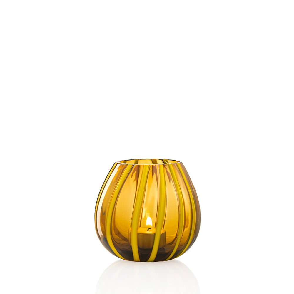 Yellow and amber striped glass tea candle holder on white background