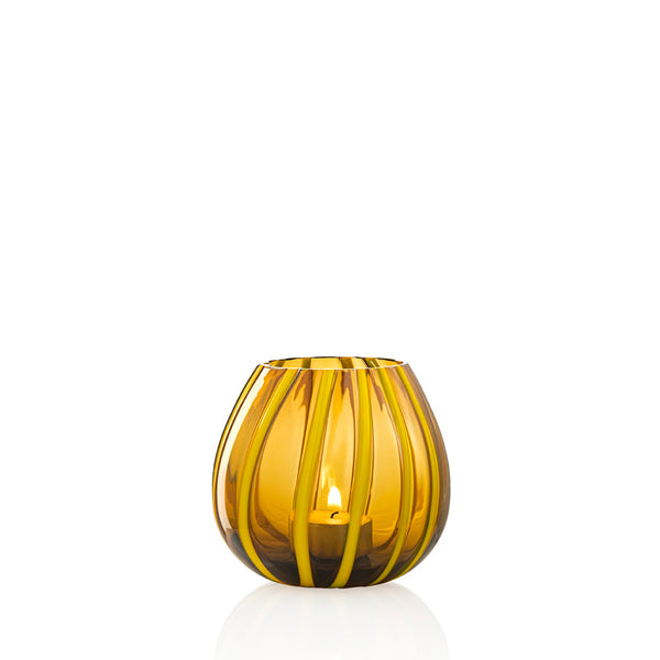 Yellow and amber striped glass tea candle holder on white background