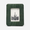 Green fabric picture frame with a photo of cacti on a white background