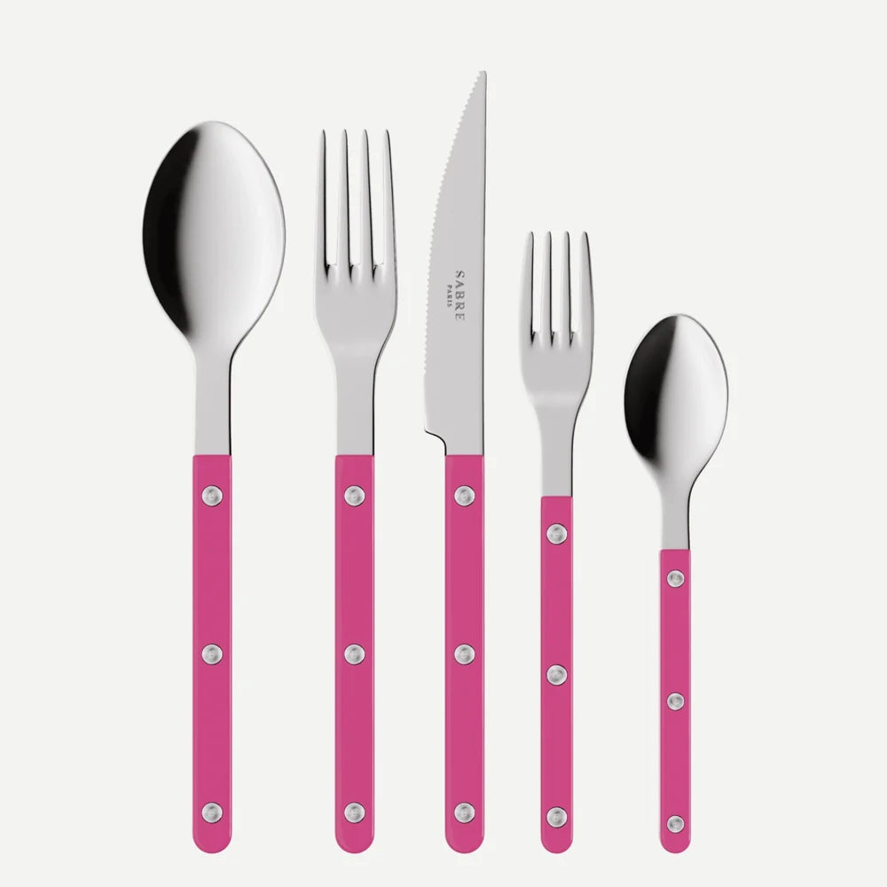 Set of silver cutlery with pink handles on a white background