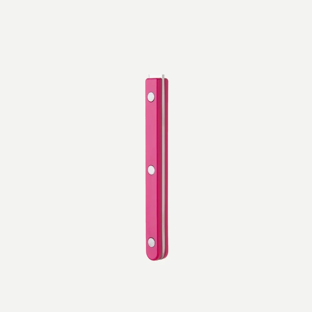 Pink handle with silver circular pads on a light gray background