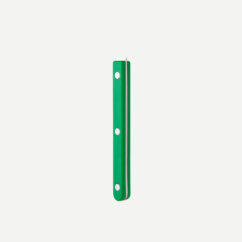 A slim green rectangular accessory with three evenly spaced white circular cutouts, shown vertically against a plain light gray background.