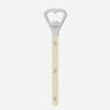 A vertical bottle opener with a cream-colored handle and a silver metal head featuring a heart-shaped cutout. The brand name 'SABRE PARIS' is printed on the metal head.