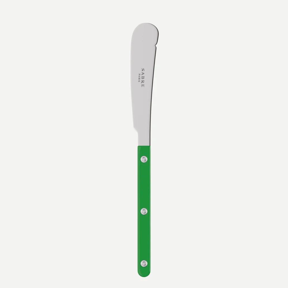 A butter spreader knife with a silver stainless steel blade and a bright green handle, shown vertically against a light gray background. The brand name 'Sabre Paris".