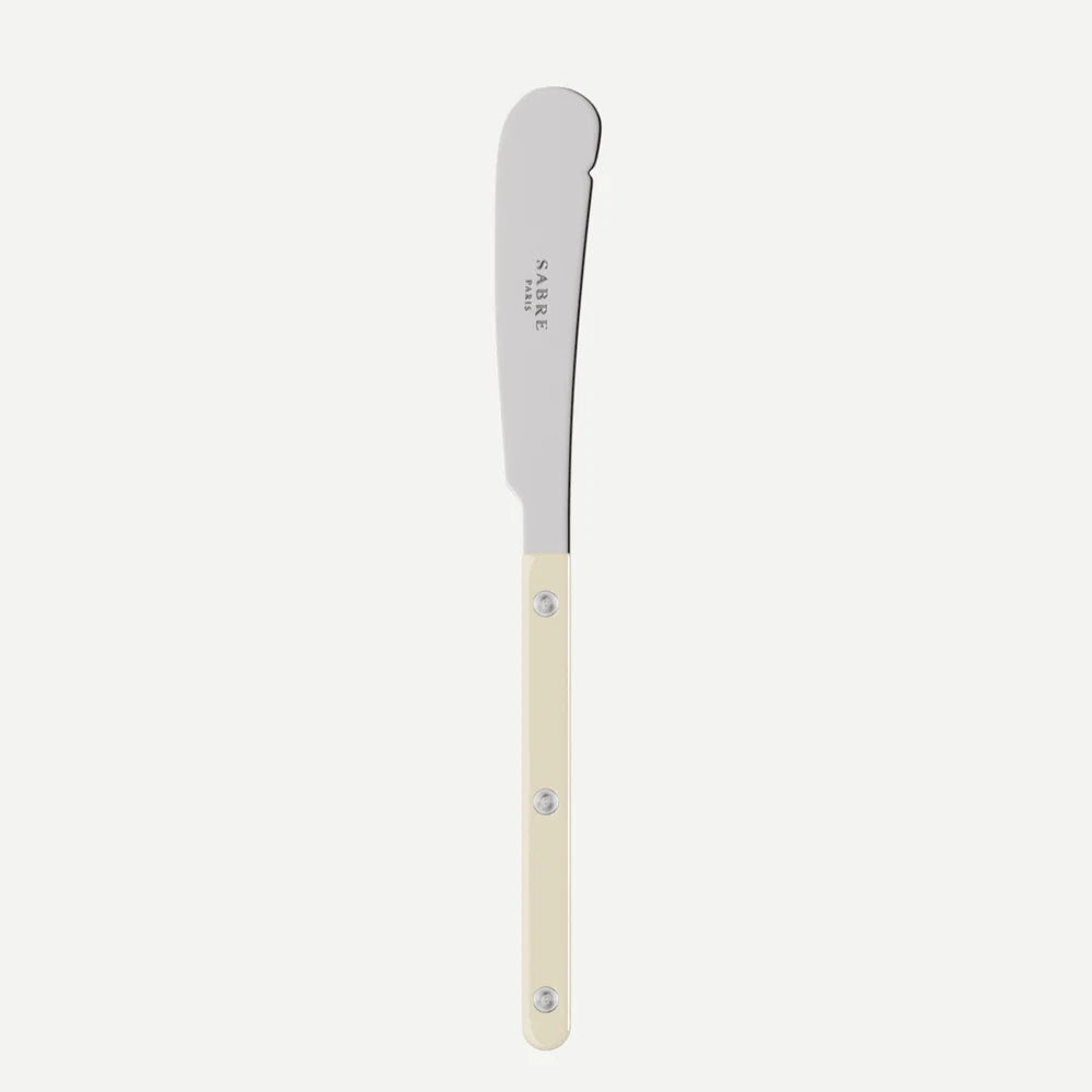 Ivory handle butter knife with "sabre paris" stamped on it on flat white background
