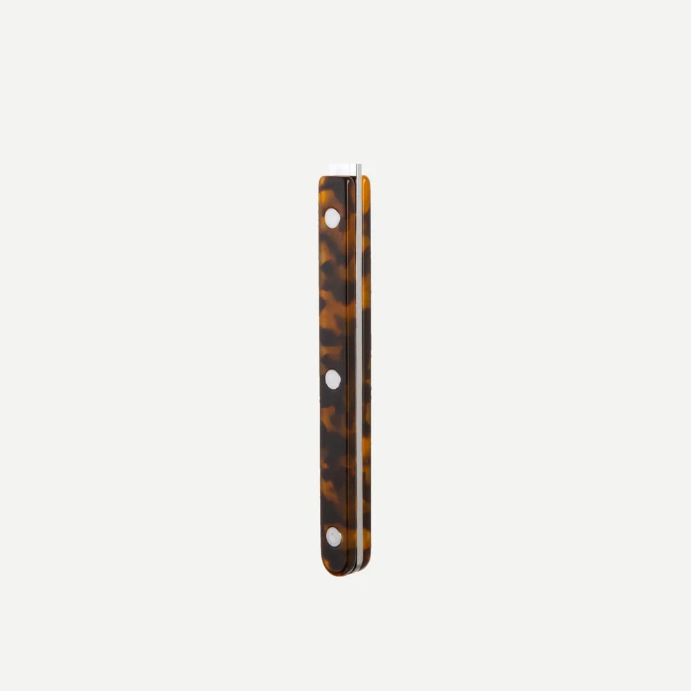 Tortoiseshell patterned handle on a white background