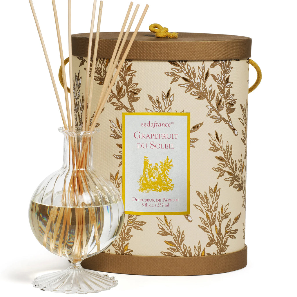 Gold and tan diffuser set with packaging on flat white background 