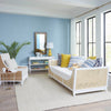 Living room with a wicker sofa, armchair, and decorative items.