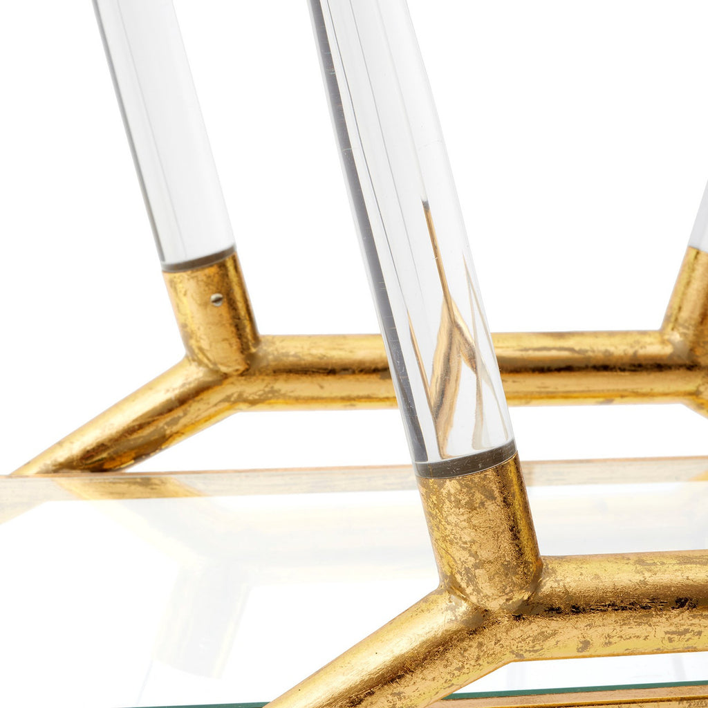 Close-up of a decorative object with gold metal and clear glass elements on a white background