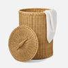 A hand-woven wicker basket hamper with a matching lid and an easy-to-lift handle, partially covered with a white towel.